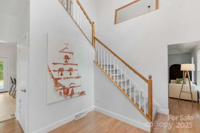 a view of entryway and hall with wooden floor