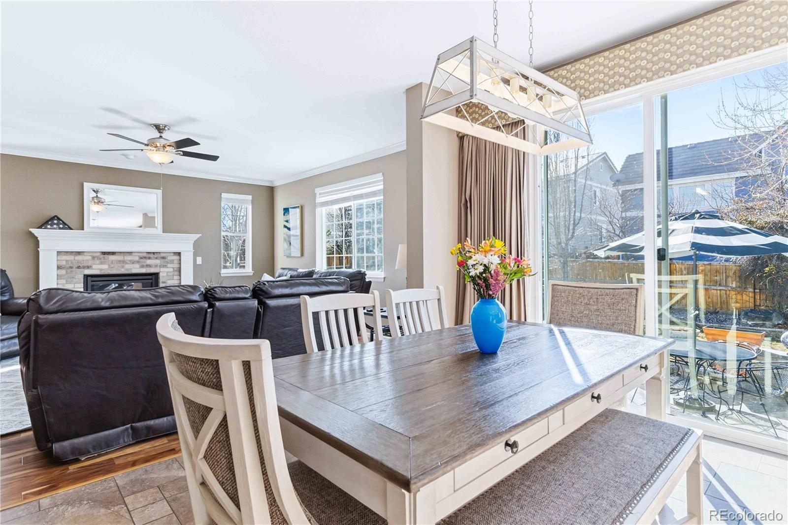 14144 Greenfield Loop Parker, CO 80134 - Photo 11 of 50 a view of a dining room with furniture window and wooden floor