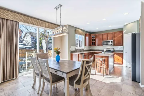 a view of a dining room with furniture a chandelier and wooden floor