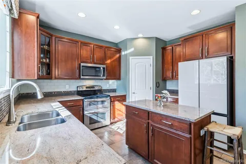 a kitchen with a sink stove and refrigerator