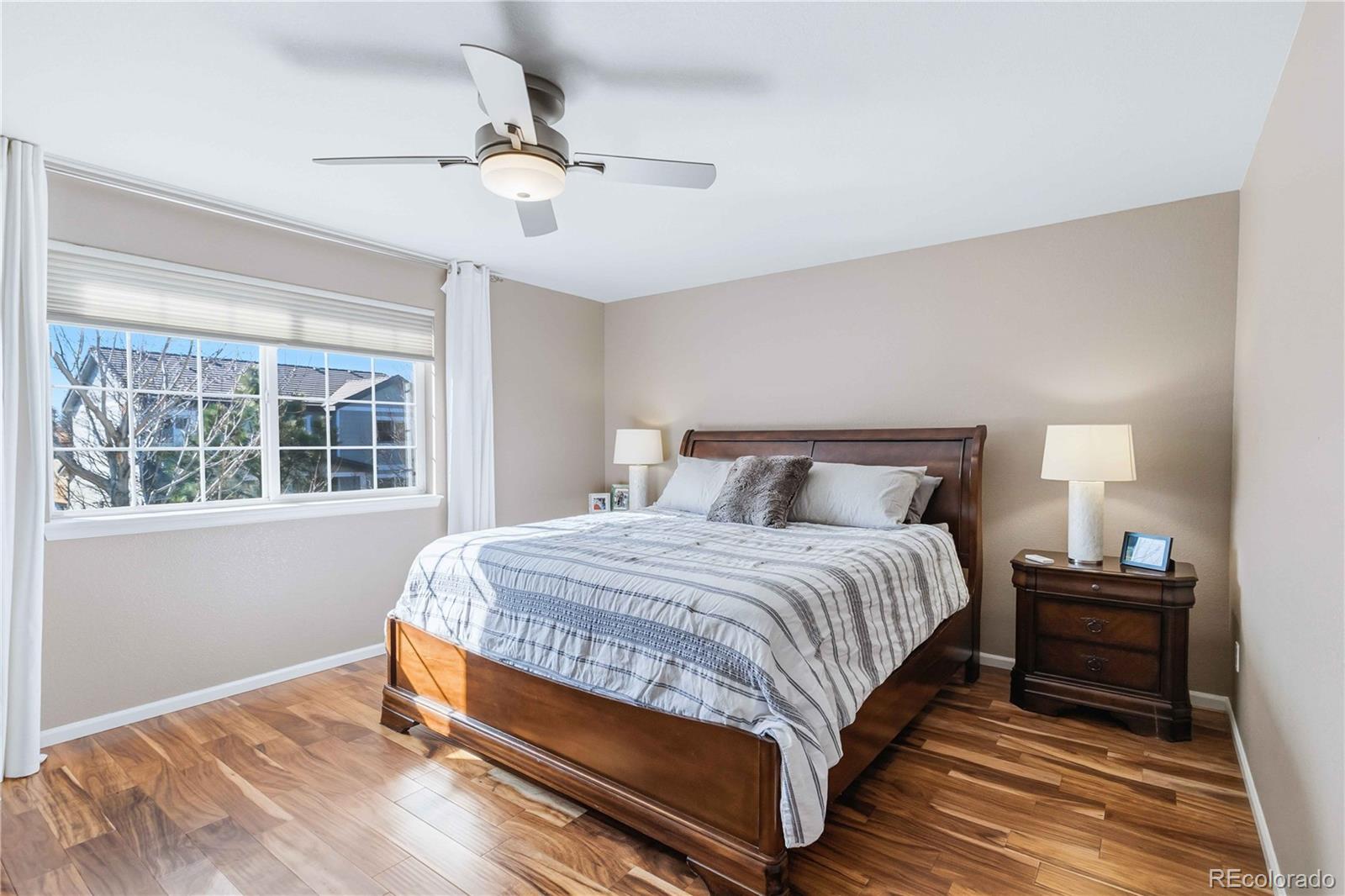 14144 Greenfield Loop Parker, CO 80134 - Photo 20 of 50 a bedroom with a bed lamp and window