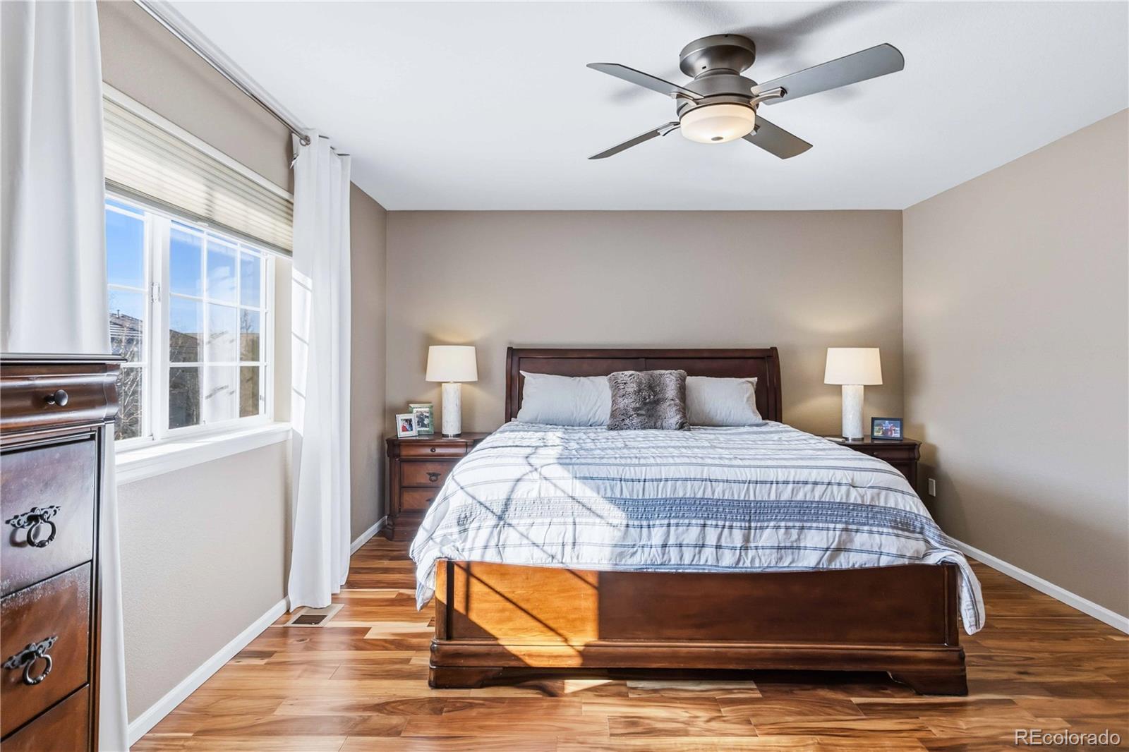 14144 Greenfield Loop Parker, CO 80134 - Photo 22 of 50 a bedroom with a bed and a chandelier