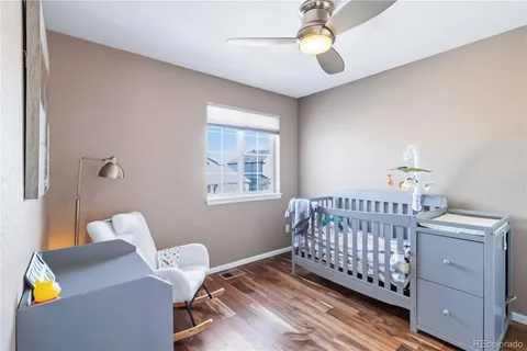 a bedroom with furniture and a wooden floor