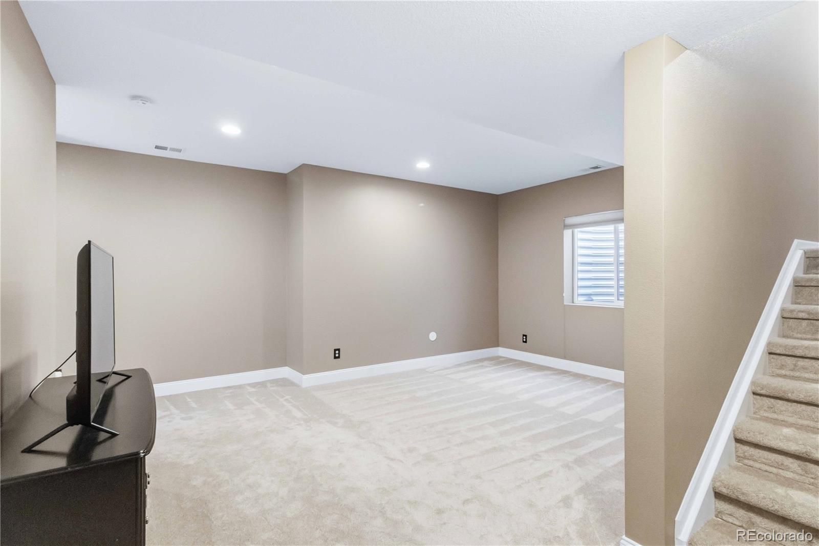 14144 Greenfield Loop Parker, CO 80134 - Photo 32 of 50 a view of an empty room with a window