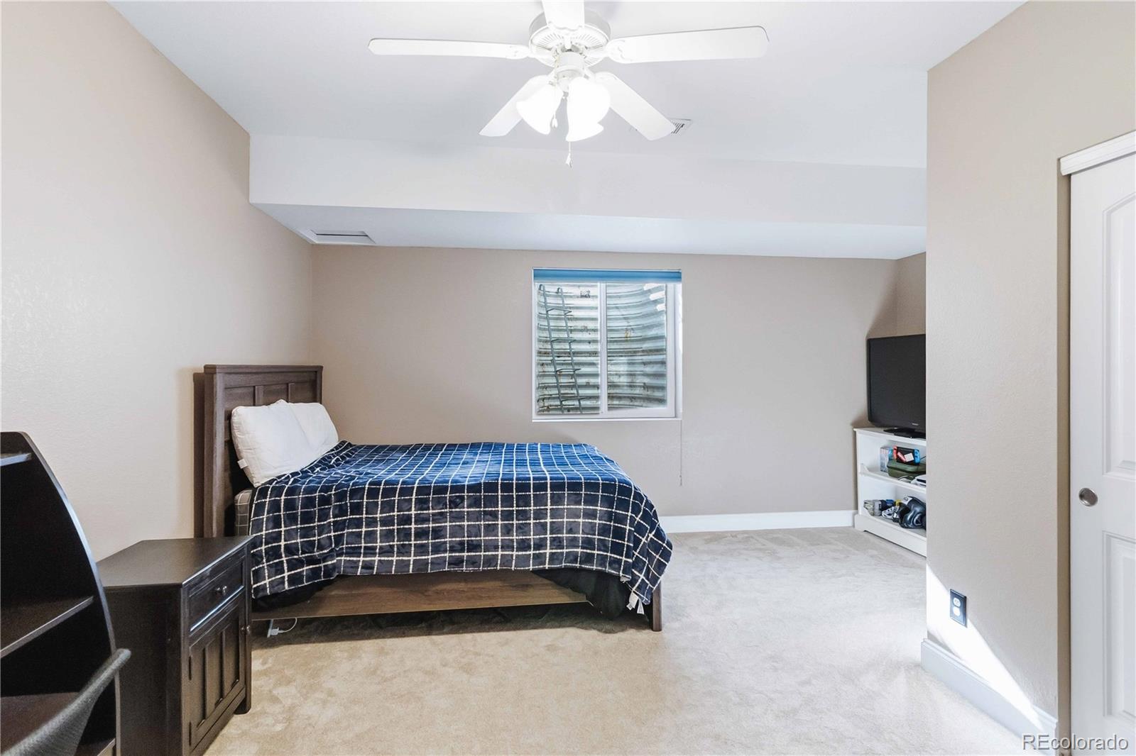 14144 Greenfield Loop Parker, CO 80134 - Photo 36 of 50 a bedroom with bed and window