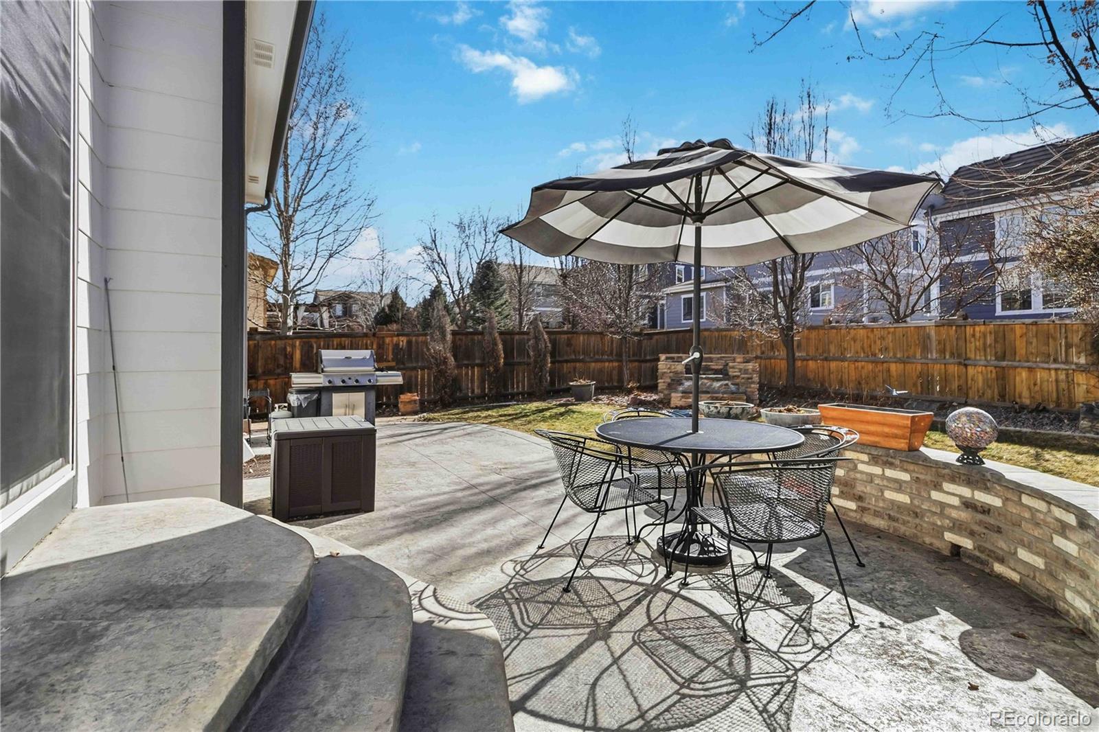 14144 Greenfield Loop Parker, CO 80134 - Photo 38 of 50 a patio with a yard table and chairs