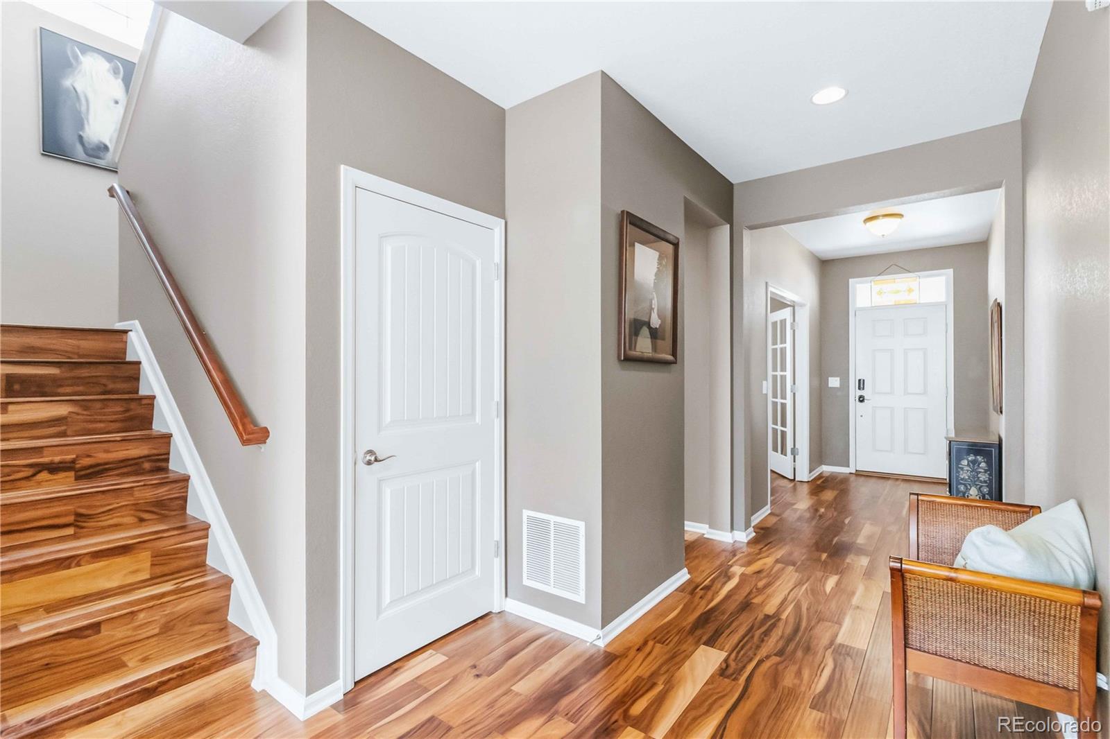 14144 Greenfield Loop Parker, CO 80134 - Photo 4 of 50 a bedroom with a bed and a chandelier