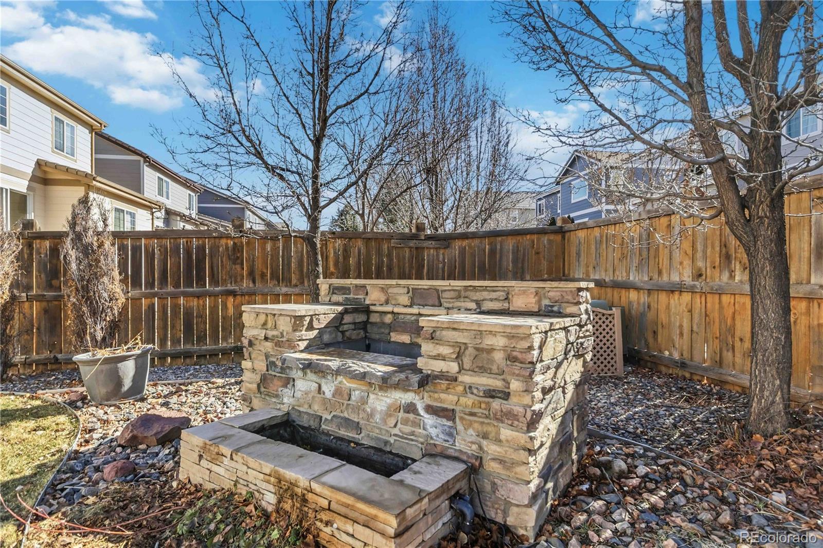 14144 Greenfield Loop Parker, CO 80134 - Photo 43 of 50 a view of roof deck with wooden fence and large trees