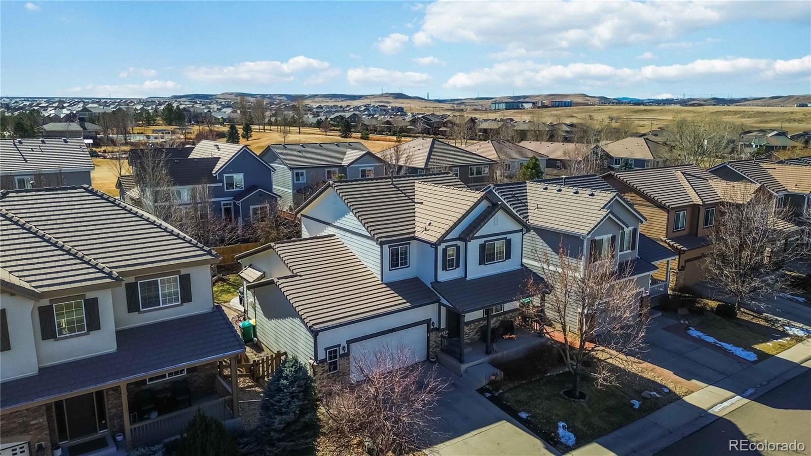 14144 Greenfield Loop Parker, CO 80134 - Photo 49 of 50 an aerial view of residential houses with outdoor space and ocean view