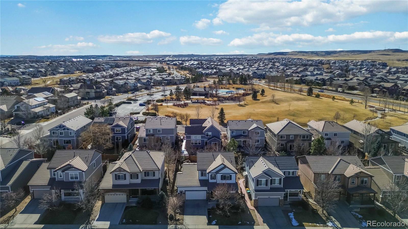 14144 Greenfield Loop Parker, CO 80134 - Photo 50 of 50 an aerial view of a house with a lake view
