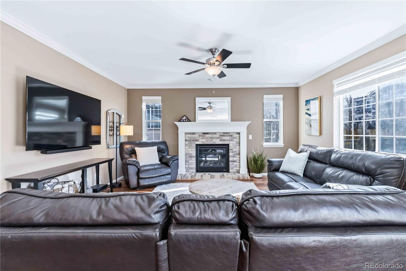 14144 Greenfield Loop Parker, CO 80134 - Photo 7 of 50 a living room with furniture and a flat screen tv