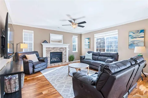 a living room with furniture a window and a fireplace