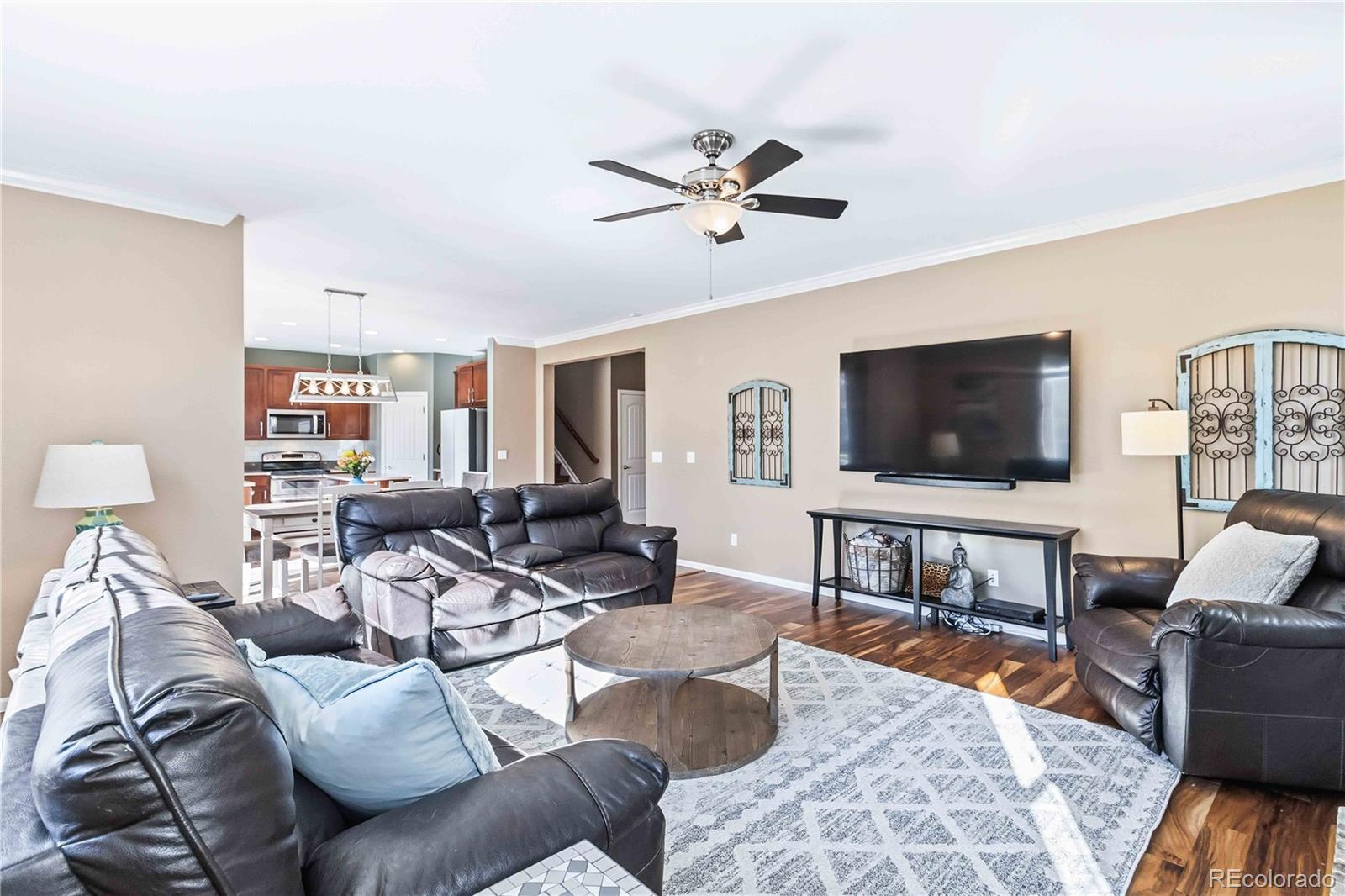 14144 Greenfield Loop Parker, CO 80134 - Photo 10 of 50 a living room with furniture and a flat screen tv