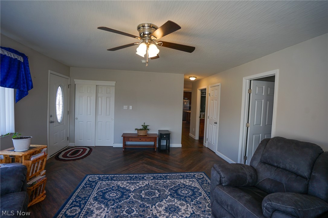 1325 County Line Road Hopewell, OH 43746 - Photo 12 of 45 Living room featuring parquet floors and a ceiling fan