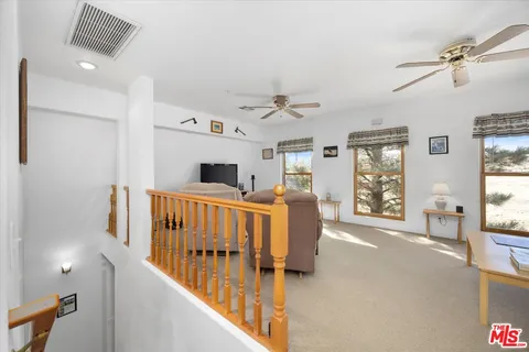 a living room with furniture fireplace and a flat screen tv