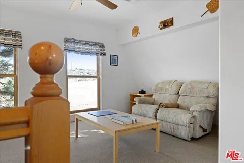 a view of a hallway with a livingroom and a bathroom
