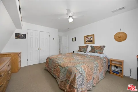 a bedroom with a bed and a chair