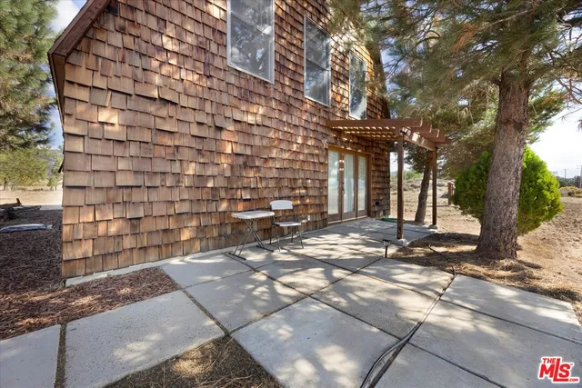 a view of backyard with wooden floor and iron stairs