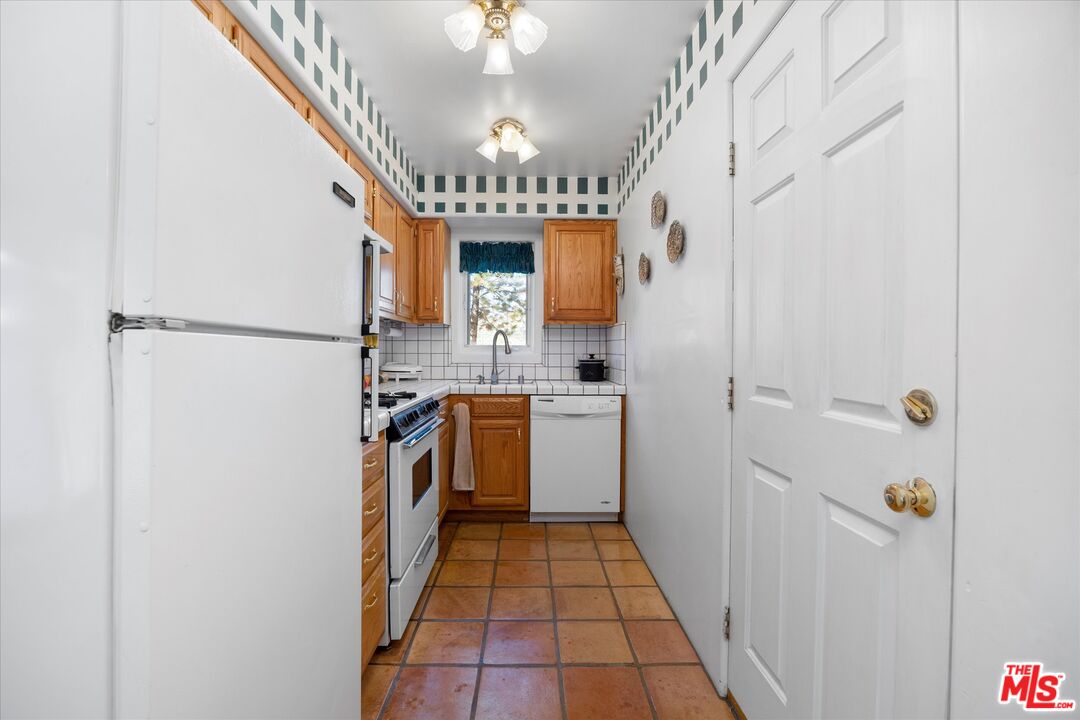 14484 Boy Scout Camp Road Frazier Park, CA 93225 - Photo 8 of 35 a kitchen with a refrigerator a sink and dishwasher