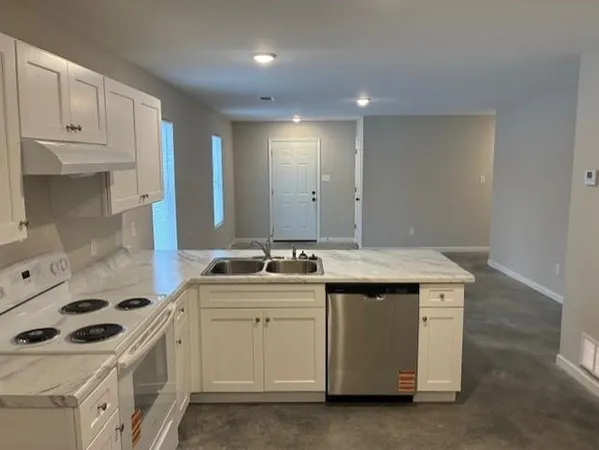 a kitchen with a sink stove and cabinets