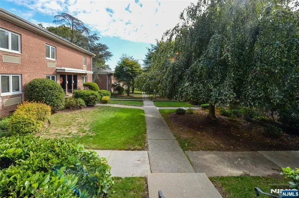 a view of a brick house with a yard