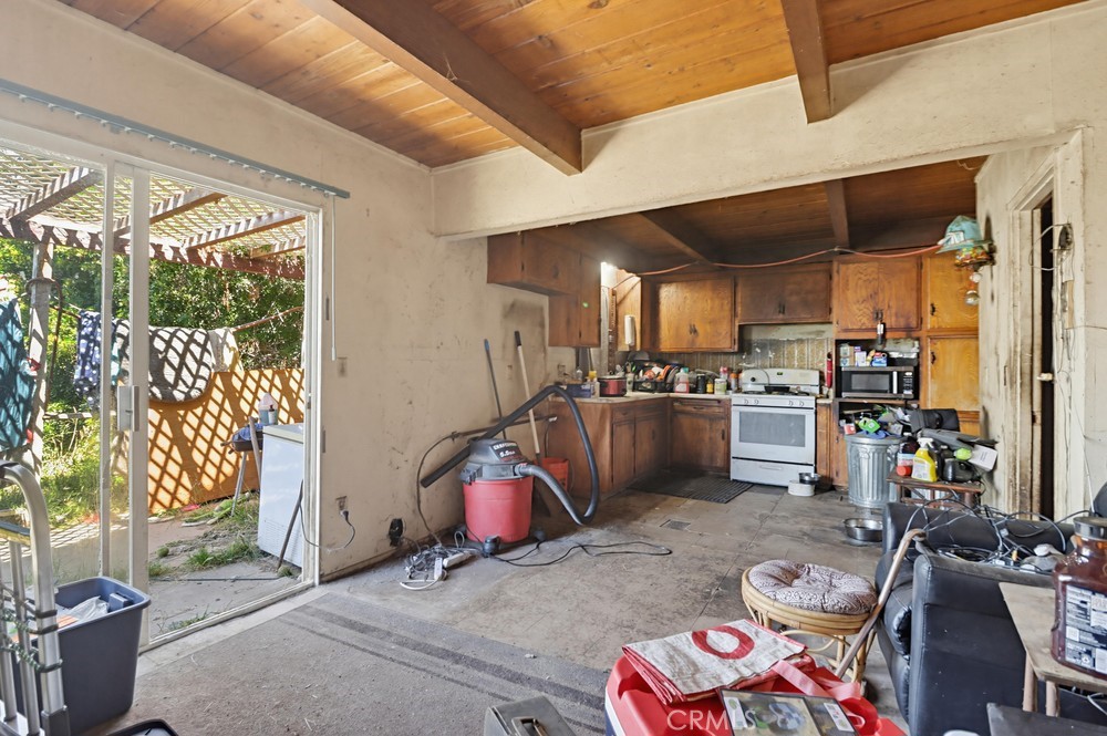 736 Sacramento Avenue Spring Valley, CA 91977 - Photo 11 of 33 a kitchen with stainless steel appliances kitchen island granite countertop a sink and cabinets