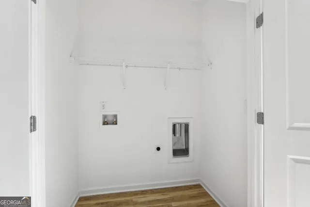 a view of a room with wooden floor and white walls