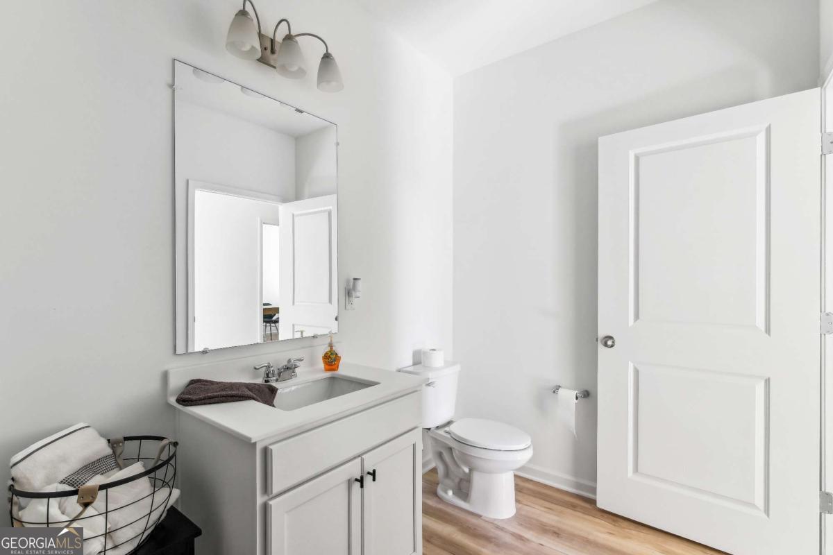 1569 Salinger Court Stockbridge, GA 30281 - Photo 18 of 26 a bathroom with a sink toilet and mirror