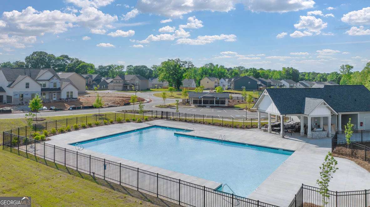 1569 Salinger Court Stockbridge, GA 30281 - Photo 25 of 26 a view of a swimming pool with lawn chairs and plants