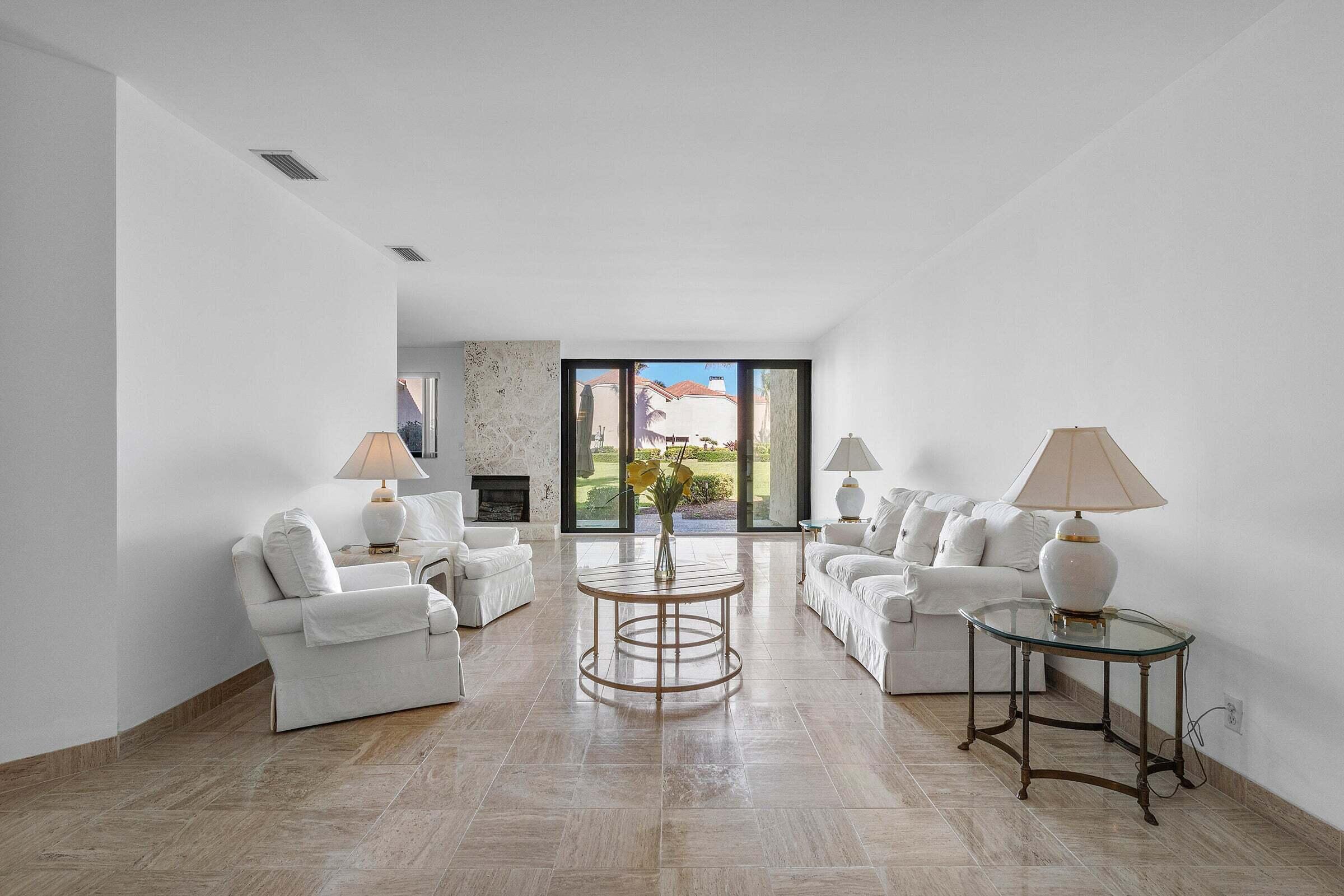 6711 North Ocean Boulevard, Unit 13 Ocean Ridge, FL 33435 - Photo 12 of 50 a living room with furniture and a large window