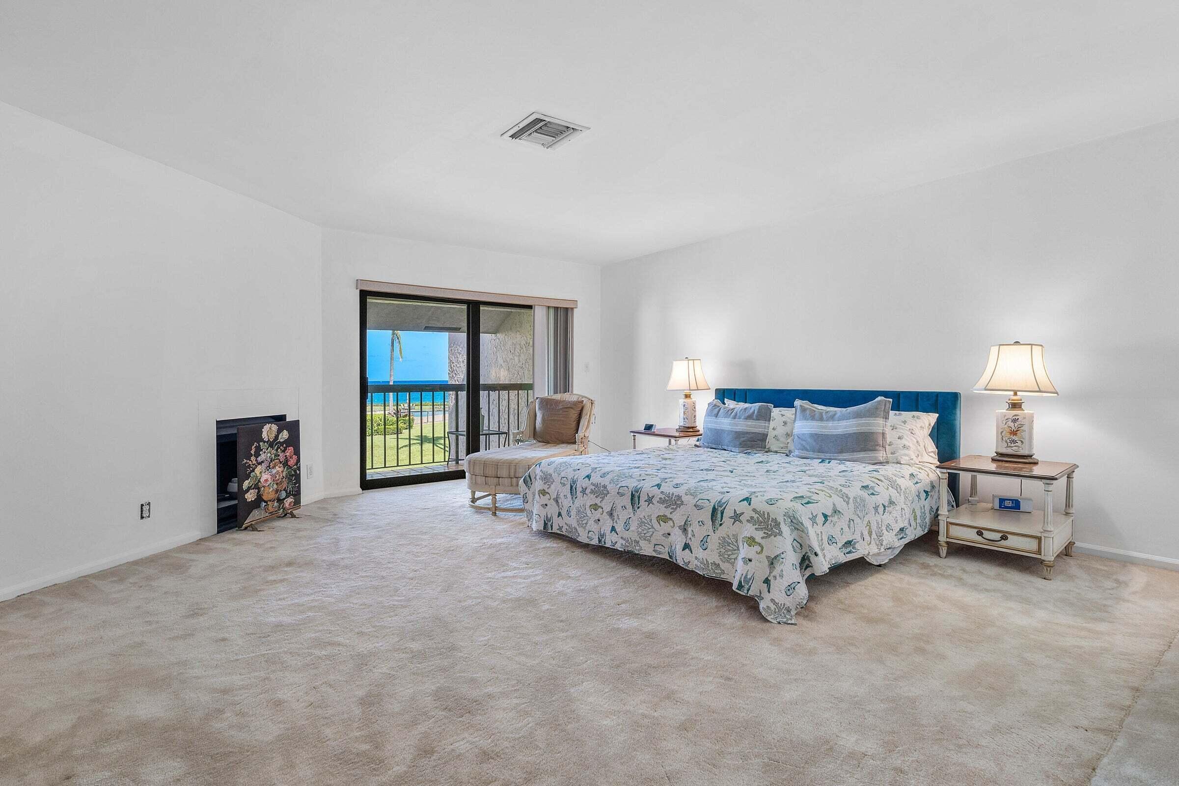 6711 North Ocean Boulevard, Unit 13 Ocean Ridge, FL 33435 - Photo 21 of 50 a spacious bedroom with a bed and a large window