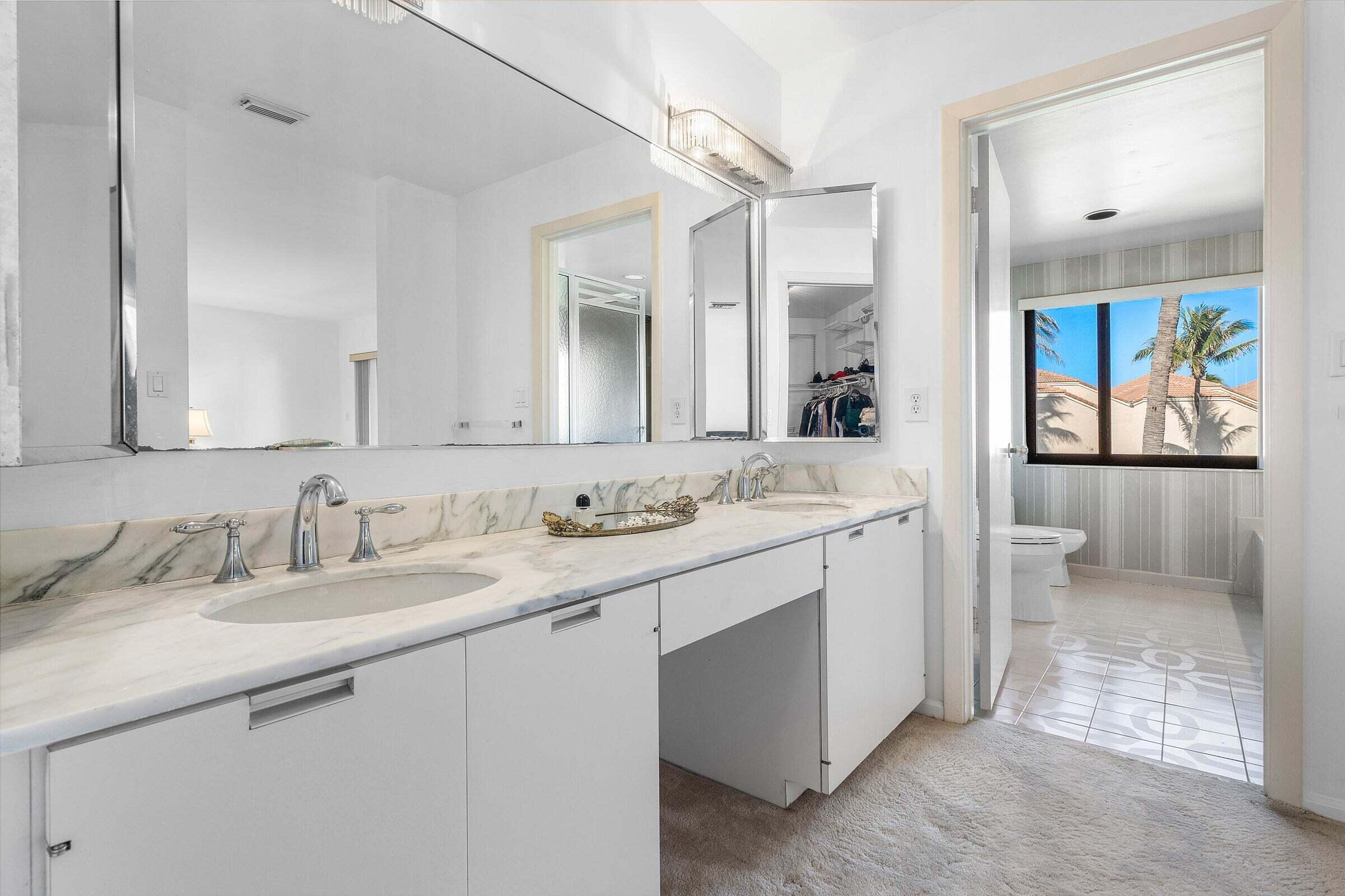 6711 North Ocean Boulevard, Unit 13 Ocean Ridge, FL 33435 - Photo 25 of 50 a bathroom with a sink a vanity and a mirror