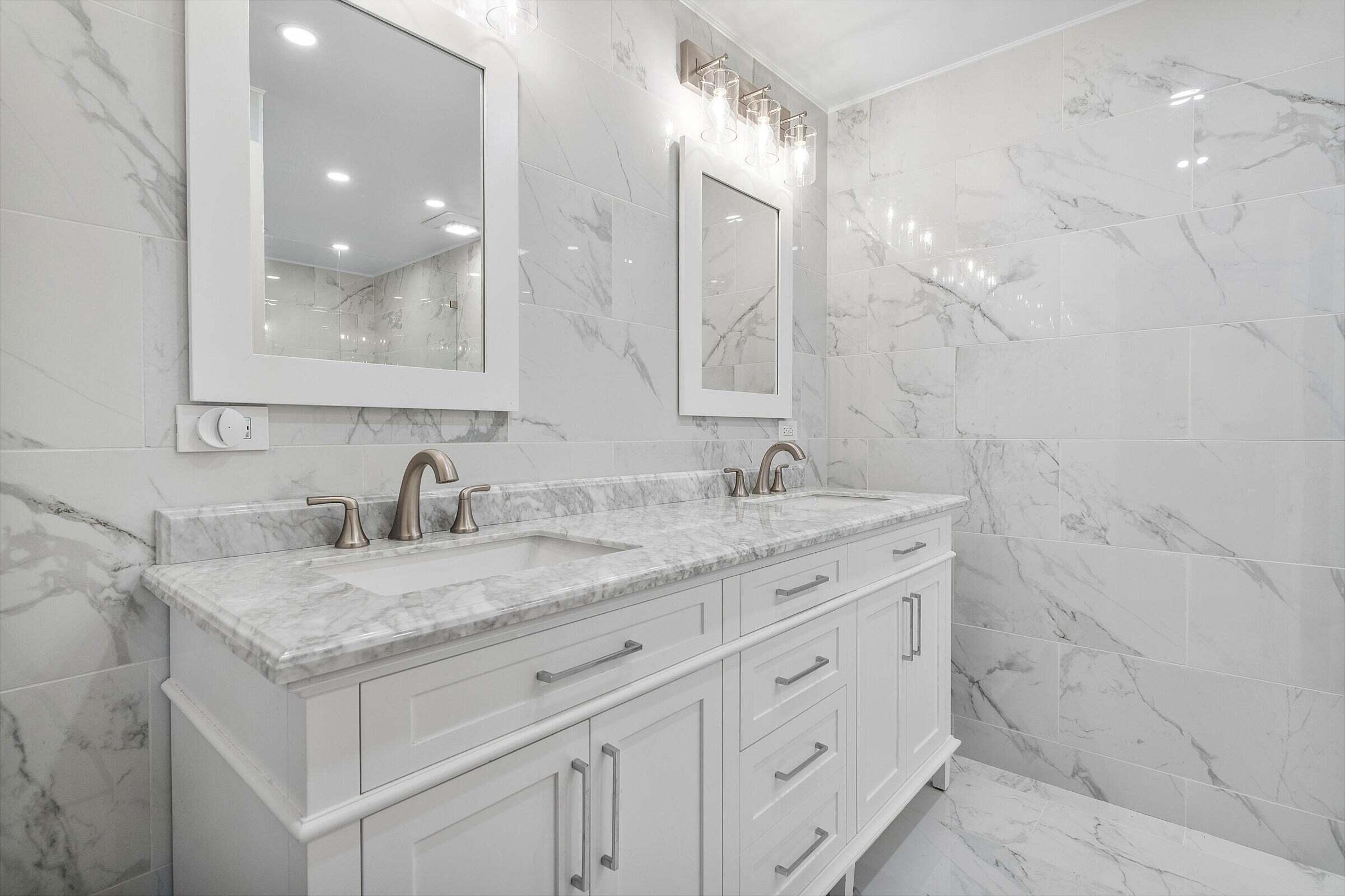 6711 North Ocean Boulevard, Unit 13 Ocean Ridge, FL 33435 - Photo 29 of 50 a bathroom with a granite countertop sink a mirror and a