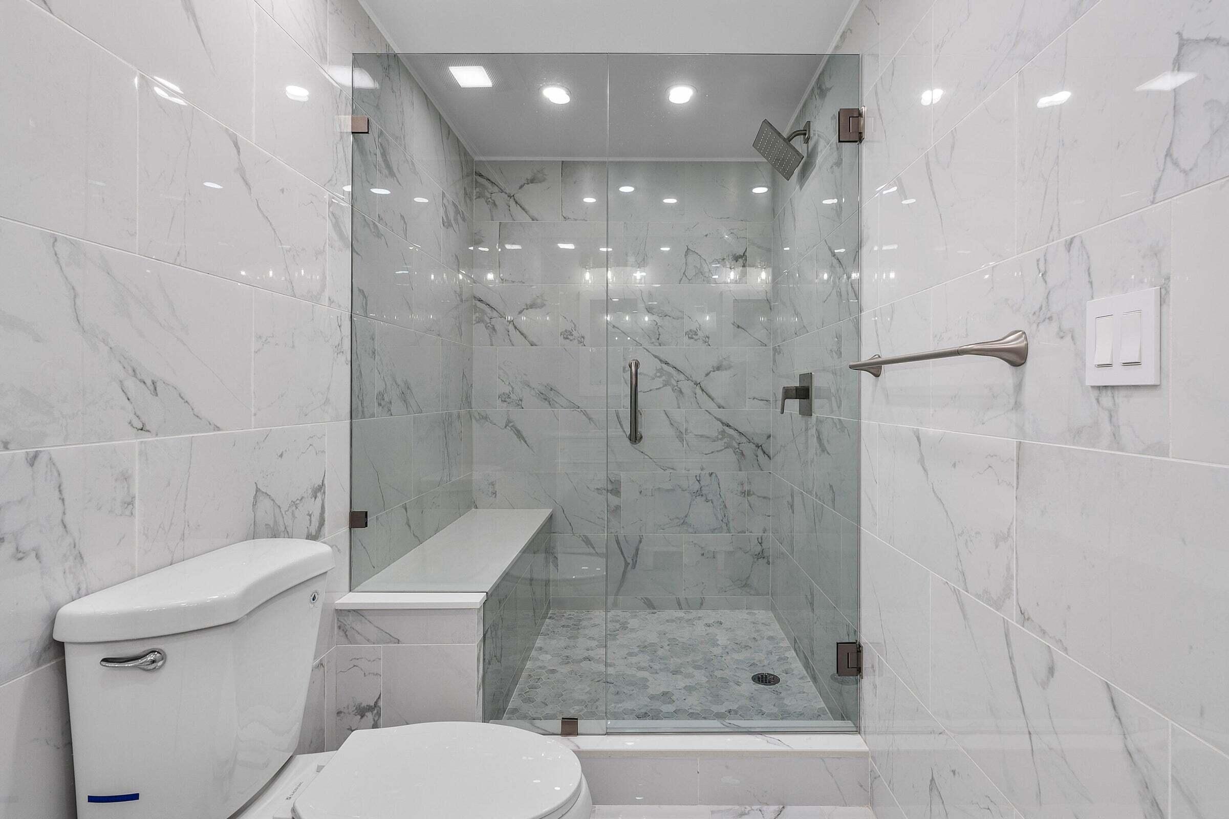 6711 North Ocean Boulevard, Unit 13 Ocean Ridge, FL 33435 - Photo 30 of 50 a bathroom with a shower a toilet and sink