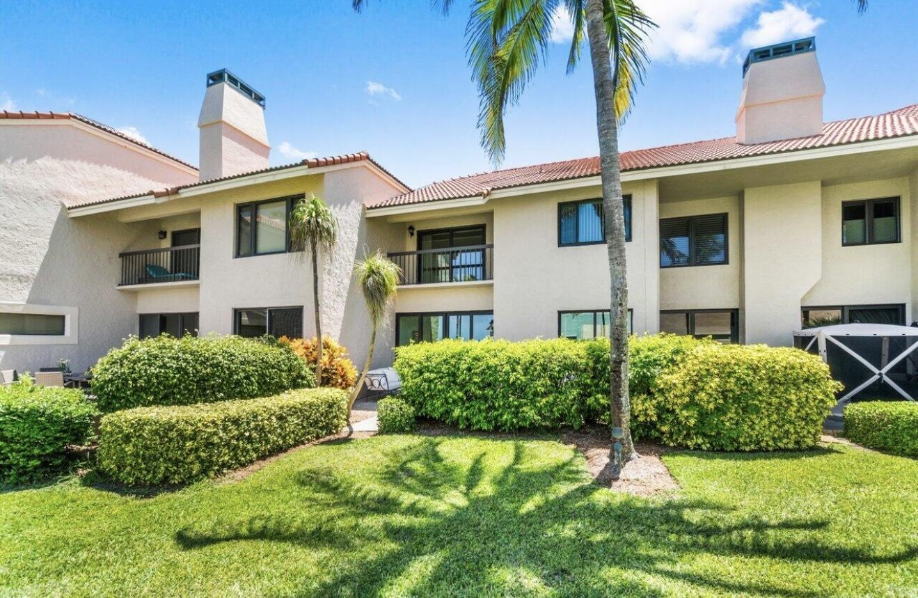 6711 North Ocean Boulevard, Unit 13 Ocean Ridge, FL 33435 - Photo 32 of 50 a front view of a house with a yard