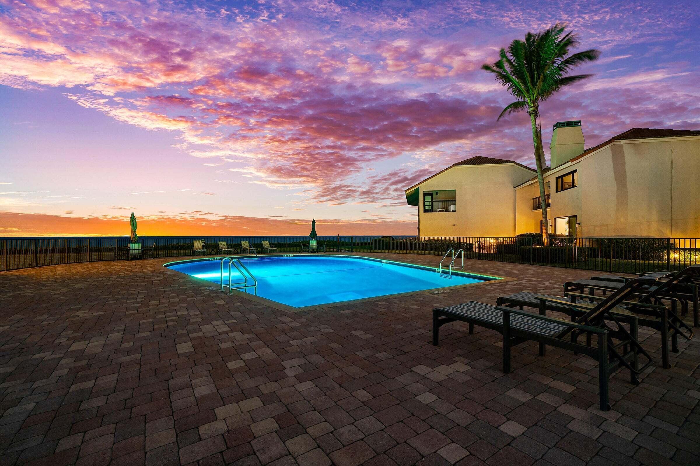 6711 North Ocean Boulevard, Unit 13 Ocean Ridge, FL 33435 - Photo 43 of 50 a view of a swimming pool with a table and chairs