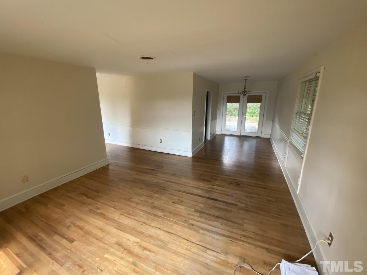 1418 Lyon Street Raleigh, NC 27608 - Photo 11 of 11 an empty room with wooden floor and windows