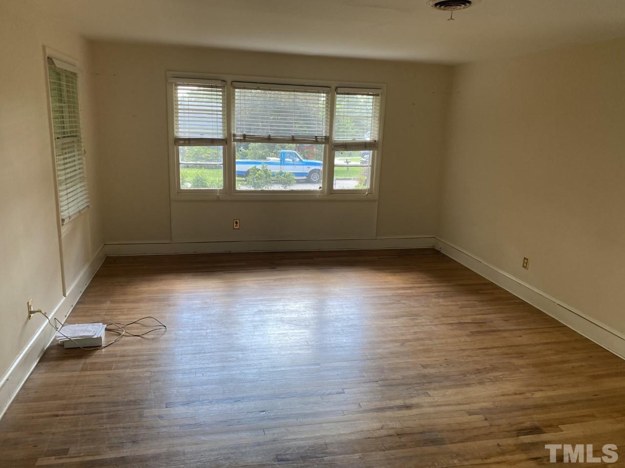 1418 Lyon Street Raleigh, NC 27608 - Photo 4 of 11 wooden floor in an empty room with a window