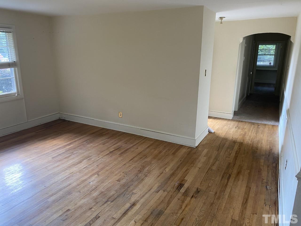 1418 Lyon Street Raleigh, NC 27608 - Photo 5 of 11 a view of a hallway with wooden floor and a window
