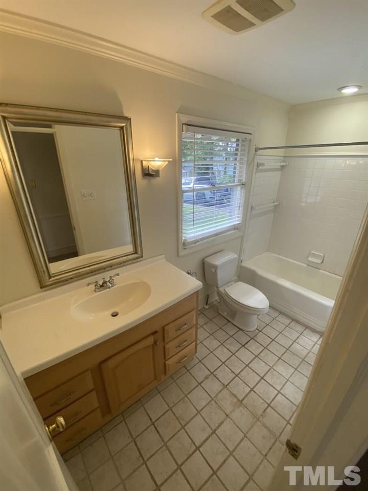 1418 Lyon Street Raleigh, NC 27608 - Photo 7 of 11 a bathroom with a sink a toilet and shower