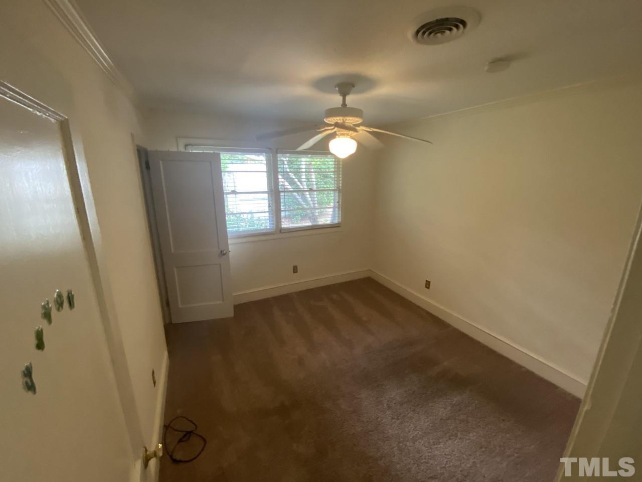 1418 Lyon Street Raleigh, NC 27608 - Photo 8 of 11 an empty room with windows and fan