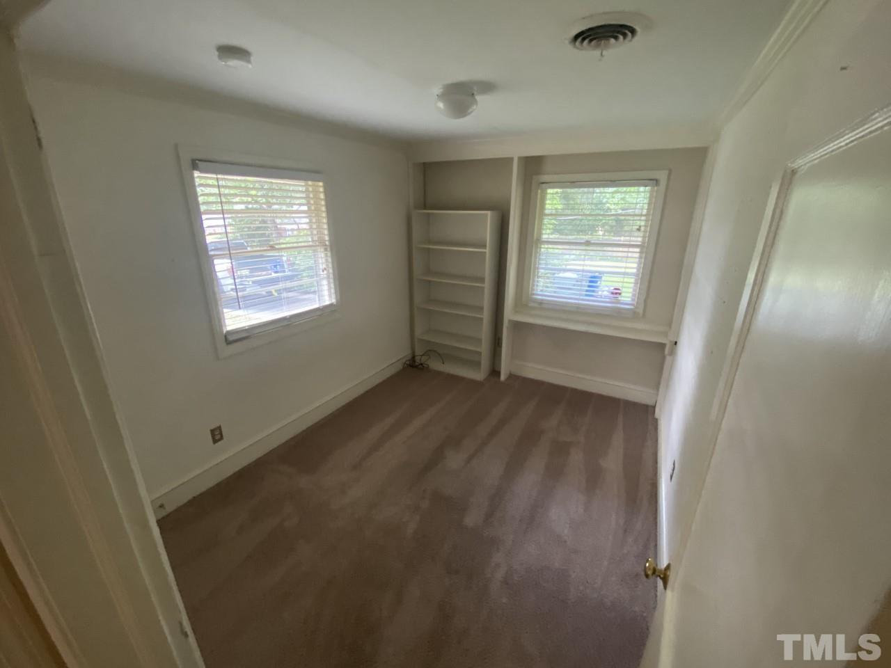 1418 Lyon Street Raleigh, NC 27608 - Photo 10 of 11 a view of empty room with wooden floor and fan