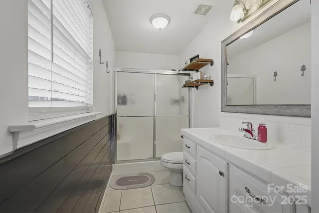 a view of walk in closet with clothes