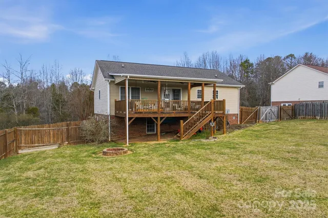 a view of a house with a yard and sitting area