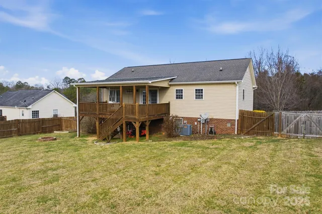 a view of a house with a big yard and a large tree