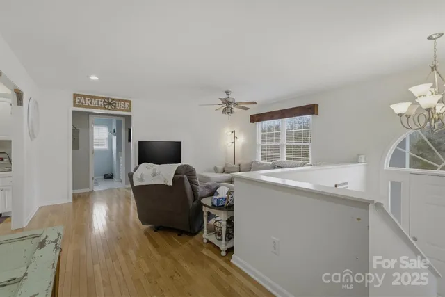 a living room with furniture a flat screen tv and a large window