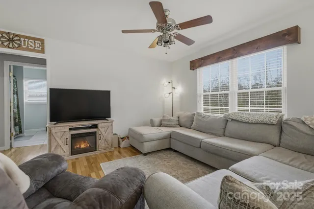 a living room with furniture and a flat screen tv