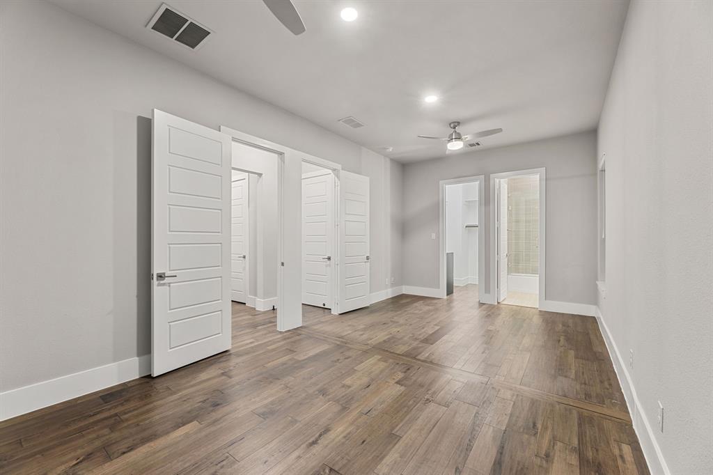 7854 Element Avenue Plano, TX 75024 - Photo 18 of 38 Unfurnished bedroom with a ceiling fan, hardwood / wood-style floors, connected bathroom, a walk in closet, and recessed lighting