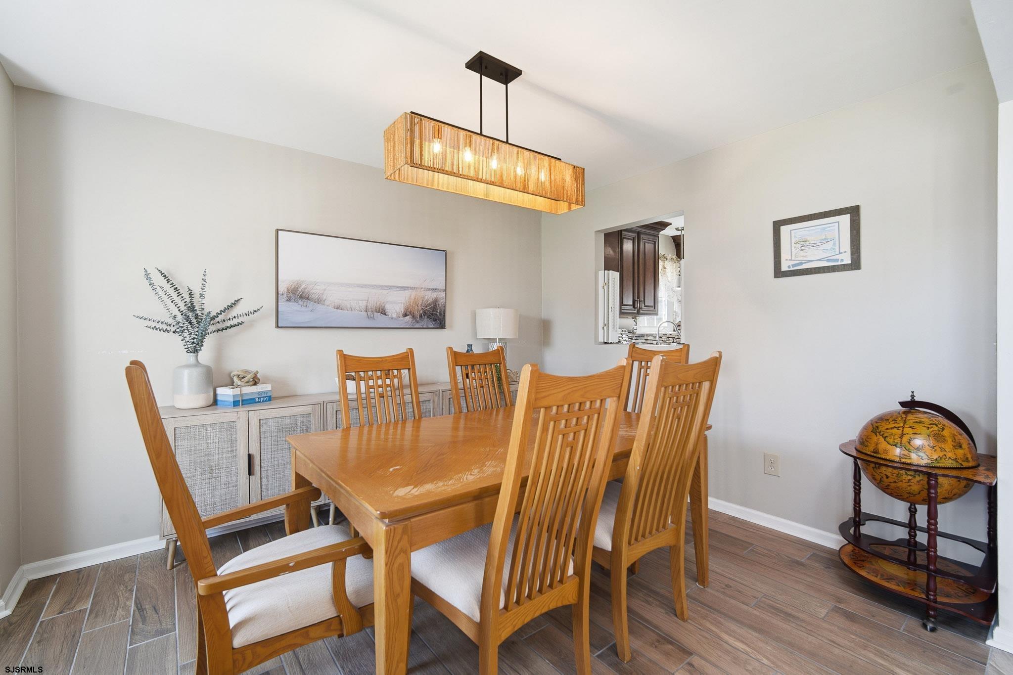 214 Hagen Road Brigantine, NJ 08203 - Photo 10 of 34 a view of a dining room with furniture and wooden floor