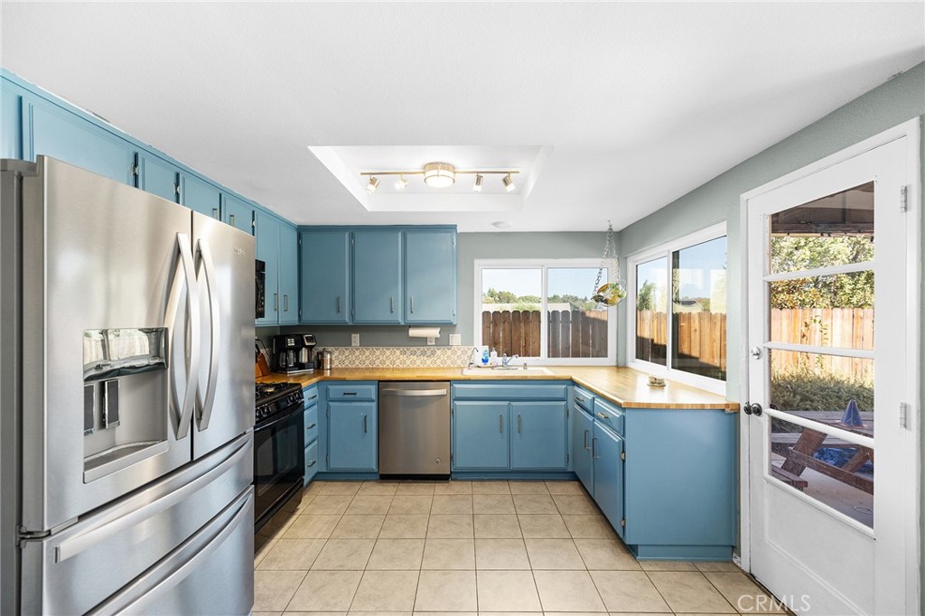 29951 Cactus Place Temecula, CA 92592 - Photo 12 of 46 a large kitchen with a large counter top stainless steel appliances and cabinets